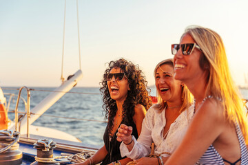 Friends laughing during boat trip in the evening light