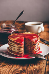 Stack of pancakes with berry jam