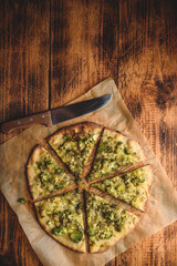 Cooked and sliced broccoli and cheese pizza