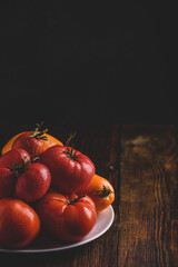 Fresh red and yellow tomatoes on plate