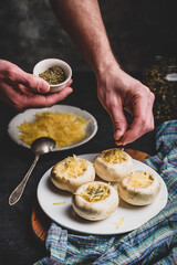 Sprinkling spices on the stuffed button mushrooms