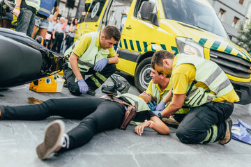 Paramedics helping crash victim after scooter accident - obrazy, fototapety, plakaty