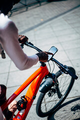 Bicycle courier using smartphone on handlebar