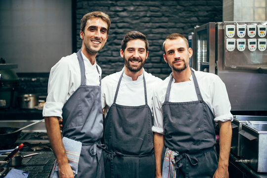 Portrait of three cooks in the kitchen of a restaurant