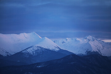 Winter alpine landscape in National Park Retezat, Carpathians, Romania, Europe. Snow covered moutains scenery 