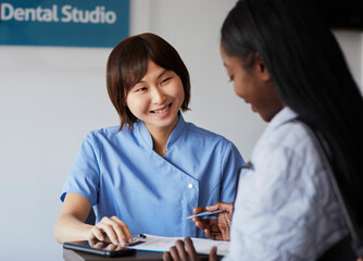 Patient at reception desk of a dental practice