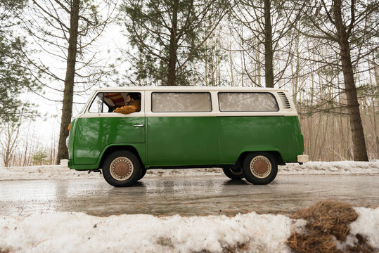 Electric van on rural road in winter landscape, Kuopio, Finland