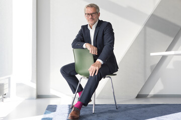 Confident businessman sitting on chair