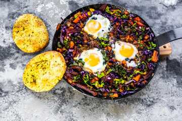 Pan of beetrootshakshoukawith chard, carrots, tomatoes, red cabbage and pita bread