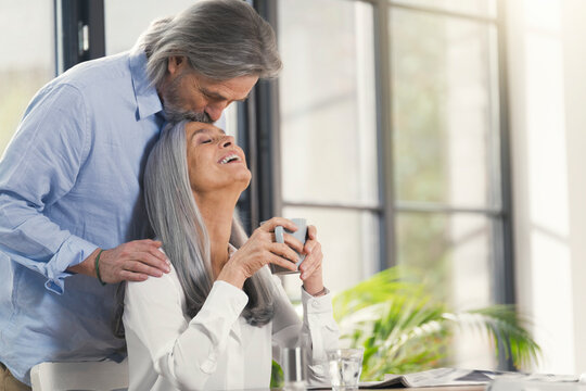 Happy Senior Couple Drinking Coffee At Home