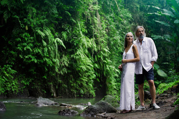 Handsome senior couple in tropical jungle
