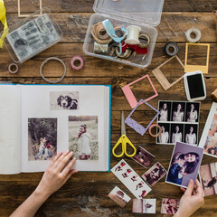 Top view of woman's hands designing photo album