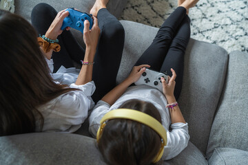Mother and daughter playing video games at home