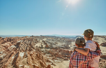 Chile, Valle de la Luna, San Pedro de Atacama, two boys looking at desert