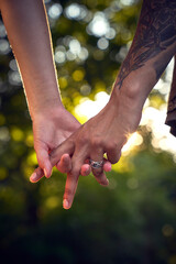 Intertwined hands of a young couple