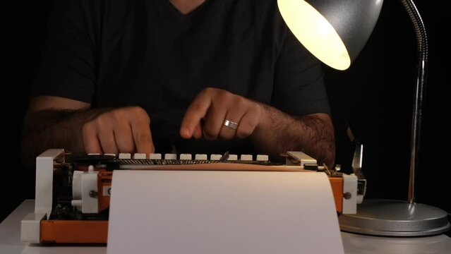 man writing with typewriter