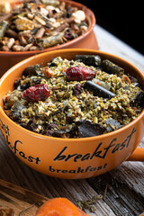 special muesli and granules for sportive horses  served in bowls around muesli background.  feeding and horse care concept.