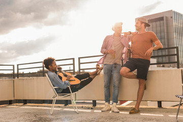 Three friends having a rooftop party