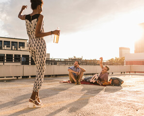 Young woman dancing on a rooftop party