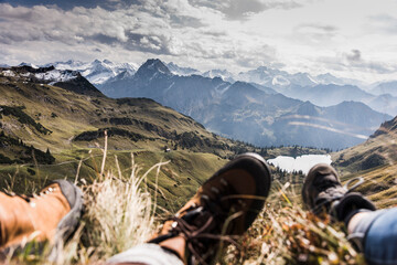 Germany, Bavaria, Oberstdorf, feet of two hikers resting in alpine scenery