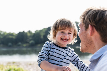 Father and son having fun at the riverside