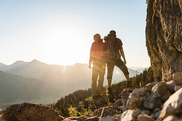 Couple standing on a mountain, looking at view