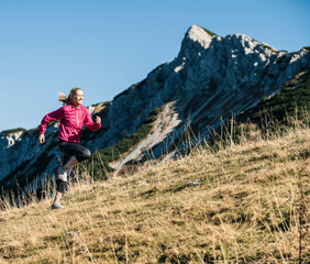 Austria, Tyrol, woman running in the mountains