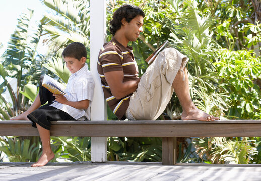 Father and Son Reading Outdoors