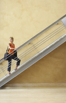 Businesswoman Walking Up Stairs