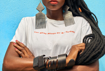 Portrait of woman with long dreadlocks wearing a T-shirt with the 'You were never my boyfriend'...
