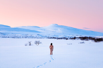 Nude man standing in winter landscape, Lebesby, Norway