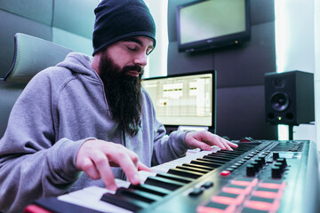 Dj producing music in his studio - Powered by Adobe
