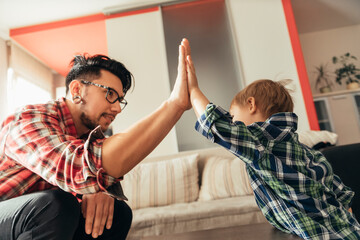 Father and son high fiving