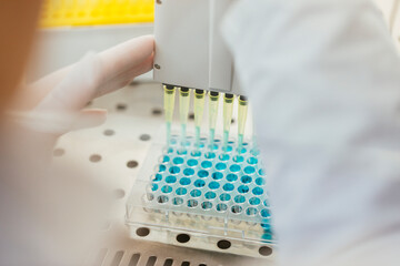 Close-up of laboratory technician pipetting in lab