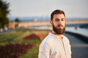 Portrait of a man with beard at a riveriside