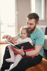 Father and daughter reading a book