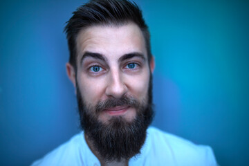 Portrait of bearded man in blue light