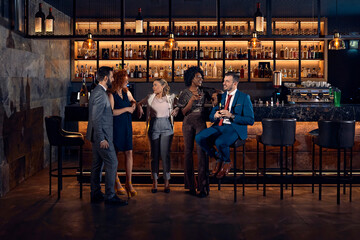 Friends socializing at the counter in a bar