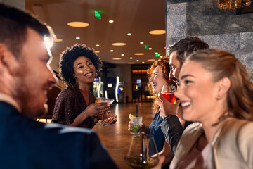 Happy friends socializing in a bar