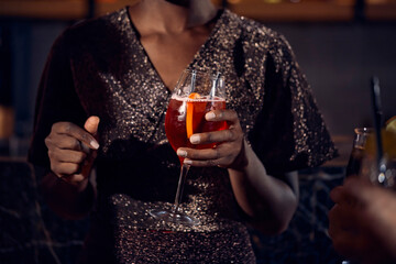 Close-up of woman holding a cocktail glass in a bar