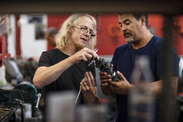 Two mechanics discussing in workshop