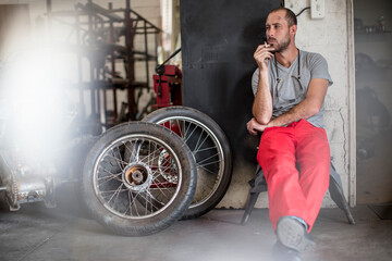 Mechanic in workshop smoking a cigarette