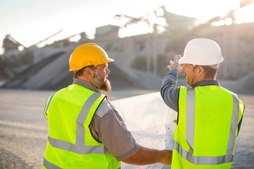 Quarry workers checking site plan