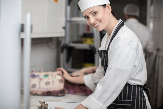 Portrait of smiling woman in a butchery