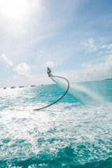Maldives, man on flyboard above the sea