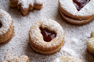 Round Linzer Christmas cookie filled with strawberry marmalade and dusted with sugar