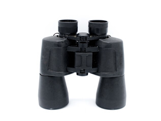 A pair of black rubber grip metal binoculars isolated on white background.  Well worn, used, dirty full of sand from being out in the field viewing wildlife.  Top view
