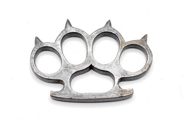 Old metal brass knuckles knuckledusters with spikes isolated on white background injuries, street...