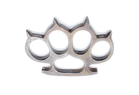 Old metal brass knuckles knuckledusters with spikes isolated on white background injuries, street fights, fights without rules, urban crime. German World War Two military era showing marks scrapes