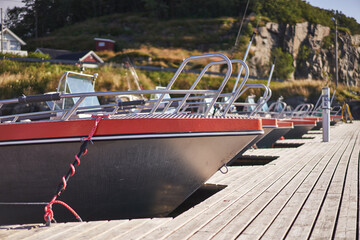 Hull of aluminium sport fishing speed boat at the public pier in the small norwegian willage....